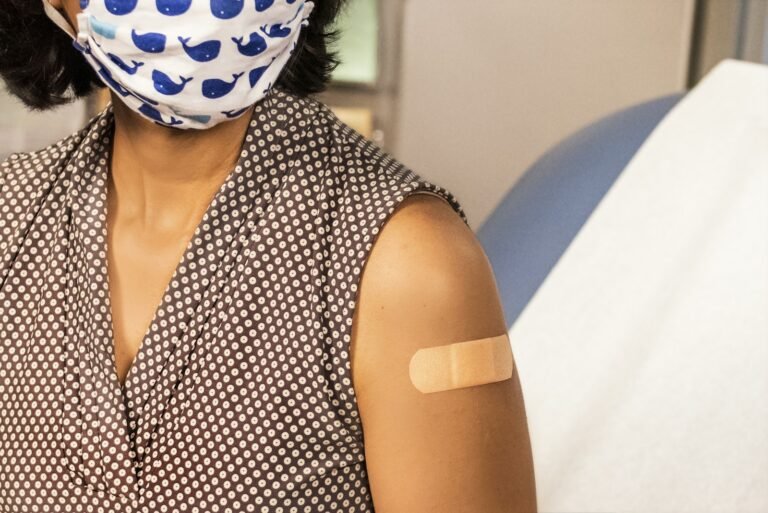 woman in black and white polka dot shirt with blue and white polka dot mask