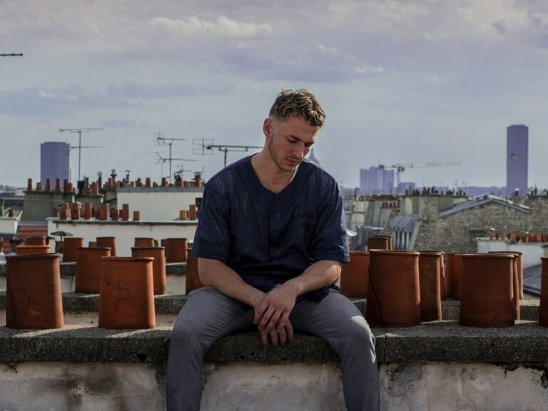 man sitting on roof deck